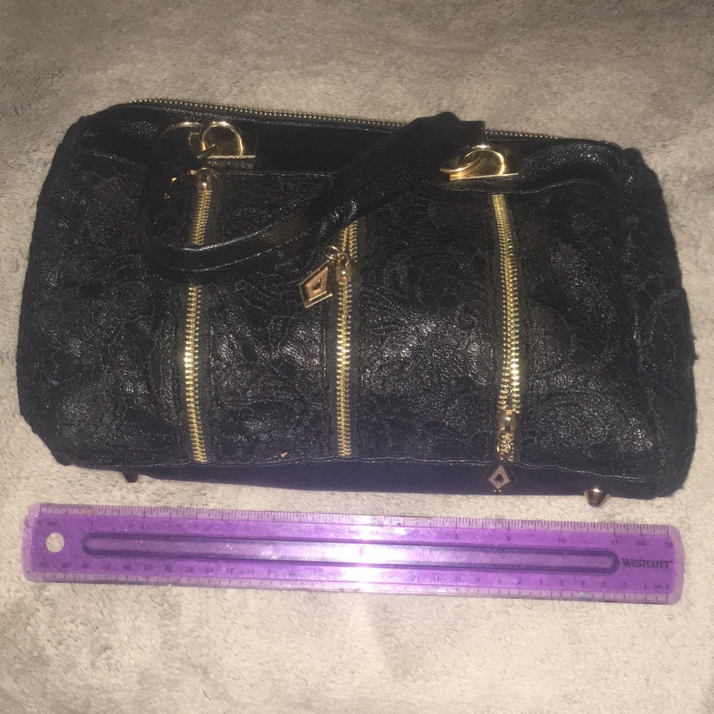 Unknown brand.  Black lace and zipper arm bag